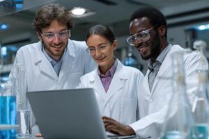 Three Scientists Collaborating on Research Project while Using a Laptop in Lab photo