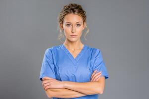 Confident Woman Doctor Surgeon in Uniform Crossing Hands over Chest Gray Background photo