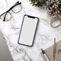 Smartphone Mockup on a Marble Background with Eyeglasses and Pen Nearby photo