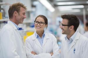 Three Scientists Collaborating on Scientific Research and Analysis in Modern Laboratory photo
