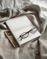 Cozy Study Corner A Blank Notebook Glasses and Pencil on a Blanket photo