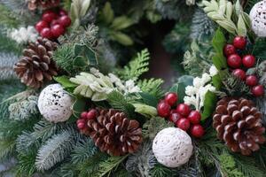 Festive Christmas Wreath Decoration with Pine Cones and Red Berries Arrangement photo
