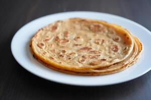 A plate with three flatbreads on it photo
