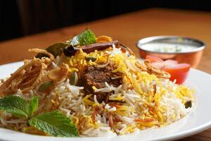 A plate of rice and meat on a table photo