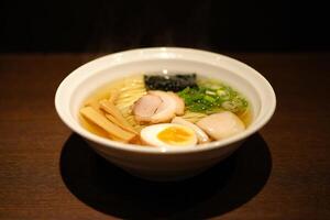 A bowl of ramen with a boiled egg and vegetables photo