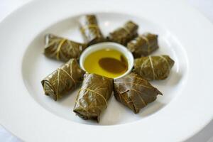 A plate with some stuffed grape leaves photo