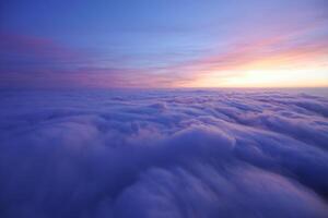 Nature Background Aerial View of Stunning Sunset Cloudscape Over a Sea of Clouds at Sunrise photo