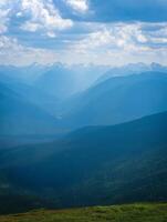 Nature Background Majestic Blue Mountains Landscape Panoramic View of Distant Peaks and Verdant Valley photo