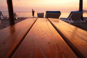 Beach Background Golden Sunset Beach Scene Wooden Table with Blurred Beach Chairs and Ocean View photo