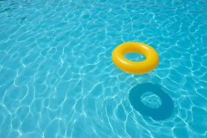 Beach Background Summer Fun Yellow Inflatable Ring in a Sparkling Blue Pool photo