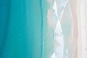 Beach Background Aerial View of Turquoise Ocean Waves Crashing on a Pristine White Sand Beach photo
