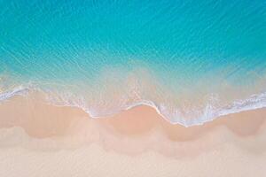 Beach Background Aerial View of Turquoise Ocean Waves Crashing on a Pristine Sandy Beach photo