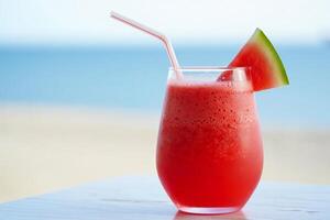 Beach Background Refreshing Watermelon Smoothie by the Beach Summer Drink photo
