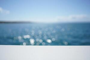 Beach Background Serene Ocean View Abstract Blurred Seascape with White Surface for Product Display photo