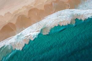 Beach Background Aerial View of Turquoise Ocean Waves Crashing on Sandy Beach Shore photo