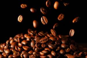 Coffee Background Roasted Coffee Beans Falling onto a Pile Dark Background Close Up photo