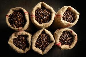 Coffee Background Aromatic Roasted Coffee Beans in Rustic Burlap Sacks Overhead View photo