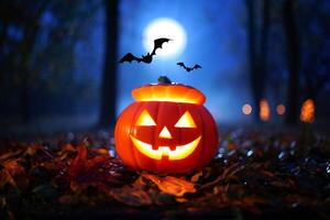 Halloween Background Illuminated Jack o lantern in Autumnal Woods at Night with Bats and Full Moon photo
