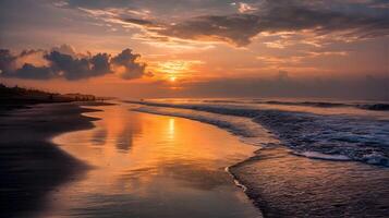Breathtaking view of the orange sunset in the sky reflecting on the wet sand of the beach photo
