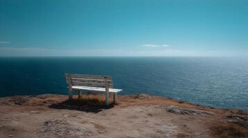 Seaside serenity bench overlooking the endless ocean meeting a calm horizon on a clear day photo