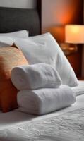 Luxurious hotel room with neatly arranged towels and pillows showcasing comfort and relaxation invitation photo