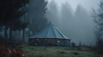 Camping under a blanket of fog a peaceful night nestled among towering pine trees photo