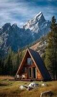 A frame cabin retreat nestled in a valley surrounded by majestic mountains and lush forest views photo
