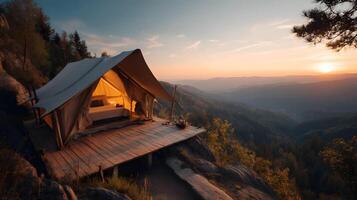 Glamping in style picturesque tent on a mountaintop at sunset offering an unforgettable adventure photo