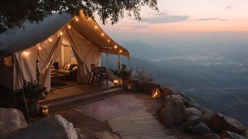 Luxurious glamping tent nestled atop a scenic mountain peak, bathed in the warm glow of sunset photo