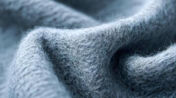 Subtle textures and folds of a luxurious angora fabric in gentle blue grey color create a soft and cozy ambiance photo