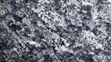 Detailed and textured granite surface shows a beautiful blend of black grey and white colors, creating a unique pattern photo