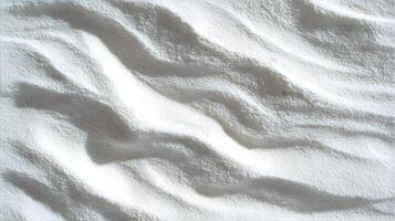 A pristine landscape of white sand dunes casting soft shadows in the bright sunlight creating an abstract pattern photo
