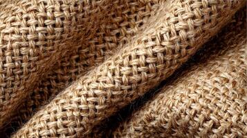 Detailed texture and pattern of natural brown burlap fabric showcasing intricate weave, offering a rustic charm and organic feel photo