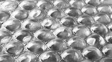 Detailed macro shot showcasing the unique texture and reflective properties of silver bubble wrap material photo