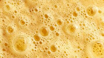 Golden bubbly texture creates a beautiful abstract background with liquid bubbles and foam design photo