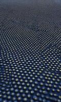 Abstract dark field with evenly spaced bright dots creating a rhythmic pattern and a sense of depth and vastness photo