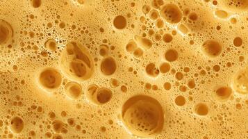 Macro shot capturing the intricate detail of beer foam texture with varied bubble sizes and golden hues photo