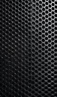 Intricate geometric pattern in dark metal surface showing repeating hexagonal cells in a structured array design photo