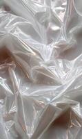 Intricate folds and mesmerizing patterns shimmering across a sheet of translucent plastic creating abstract textures and depth photo