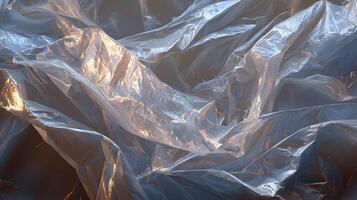 Abstract glistening plastic sheet background texture pattern illuminated by sunlight highlighting the creases photo