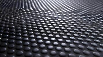 Dark metallic surface with evenly spaced bumps creating a textured abstract background image photo