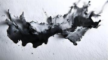 Ink blot on white paper creates a dramatic and abstract visual texture with organic and flowing form photo
