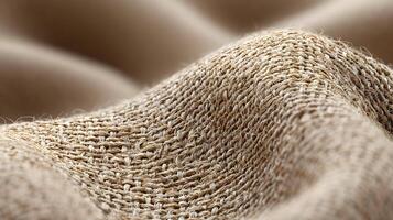 Detailed view of burlap fabric revealing its coarse texture and complex woven pattern in warm neutral tones photo