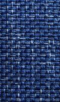 Detailed close up showcasing a woven fabric texture in varying shades of blue emphasizing depth and pattern intricacy photo