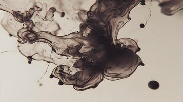 Black ink swirling in water against a light backdrop creating an abstract fluid motion design photo
