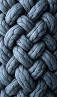 A tightly woven pattern of large soft blue yarn creating a cozy and comforting texture throughout frame photo