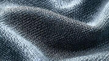Intricate close up of woven metal mesh fabric creating a textured surface with subtle folds and shadow photo