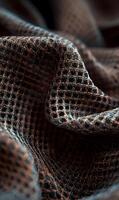 Intricate weaving a close up view of textured fabric in a brown and black color palette displaying elegant folds and patterns photo
