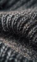 Intricate texture of a cozy woolen knit creating warmth and depth in a monochromatic grey palette photo