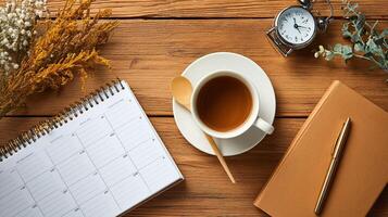 Cozy Workspace with Tea, Clock, and Notebook on Wooden Desk photo